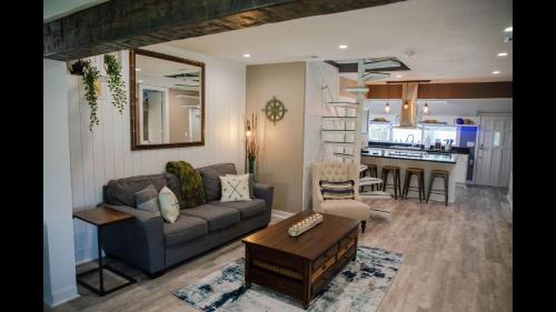 a living room with a couch and a table at Family Home with Private Pool Yard Only 24 Mi to Disney in Saint Cloud