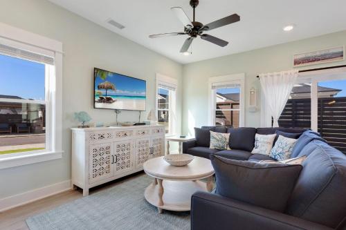 a living room with a blue couch and a tv at BCW30A - Waves Inn in Corolla