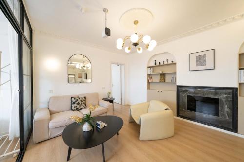 a living room with a couch and a fireplace at Shanghai Yi Du B&B - Family Suite 500m to Nanjing West Rd Near People's Square -Credit Cards Accepted in Shanghai