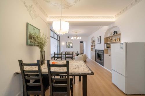 a kitchen and dining room with a table and a refrigerator at Shanghai Yi Du B&B - Family Suite 500m to Nanjing West Rd Near People's Square -Credit Cards Accepted in Shanghai