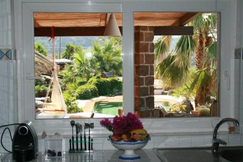 a kitchen window with a bowl of fruit on a counter at Dammusi Ambra in Pantelleria