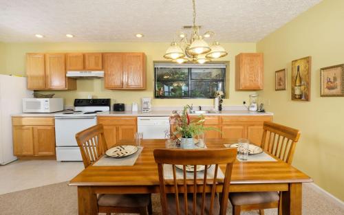 a kitchen with a wooden table with chairs and a dining room at Among The Clouds 2240 in Gatlinburg