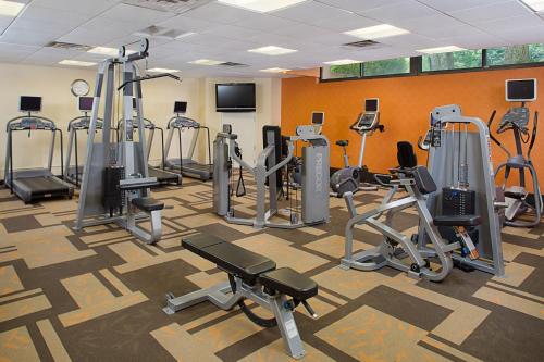 a gym with a lot of treadmills and machines at Courtyard Montvale in Montvale