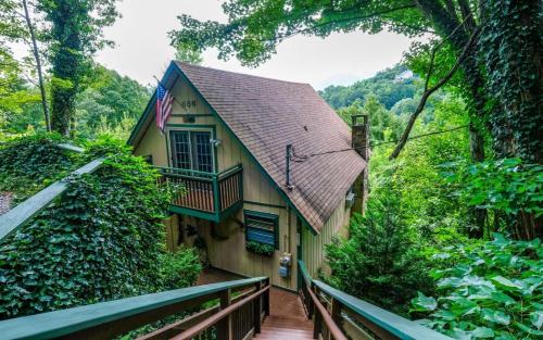 a house with a balcony and an american flag at Cozy Bear 856 in Gatlinburg