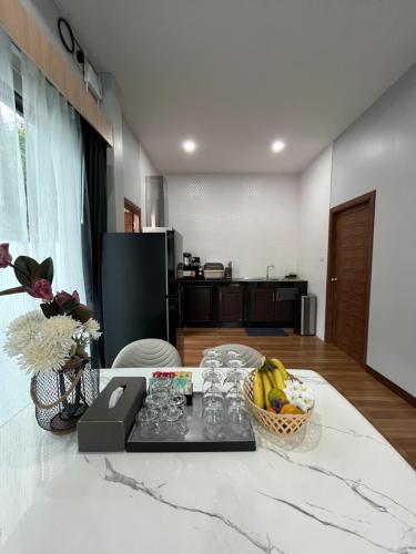 a living room with a table with a bowl of fruit at The M Millions Pool Villa, Aonang Krabi -Free Shuttle to Aonang Beach in Ao Nang Beach