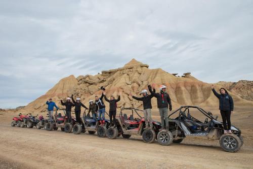 a group of people standing on four wheelers in front of a mountain at RuralSuite Hotel Apartamentos in Cascante