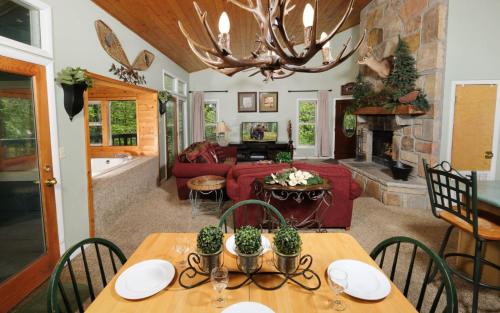 a living room with a table and a fireplace at Ski Mountain Hideaway 1154 in Gatlinburg