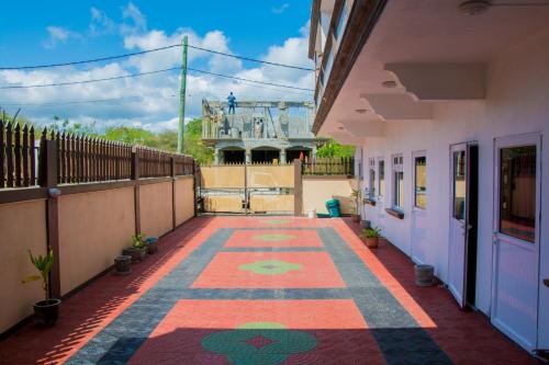 a courtyard of a house with a tile floor at Sunshine Villa in Grand Baie