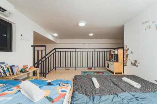 a bedroom with a bed with two controllers on it at Wonderland Loft Sunway Grid Kid Friendly by Our Stay in Iskandar Puteri