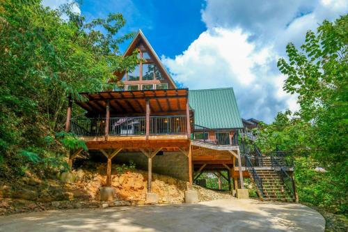 a large wooden house on a hill with stairs at Patriots Den in Gatlinburg