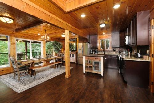 a large kitchen with wooden floors and wooden ceilings at Patriots Den in Gatlinburg