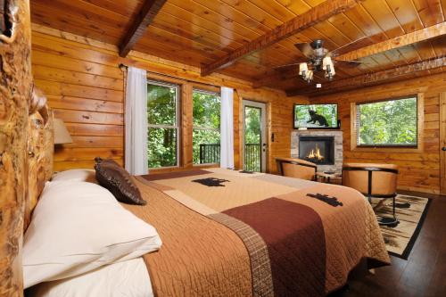 a bedroom with a bed in a log cabin at Patriots Den in Gatlinburg