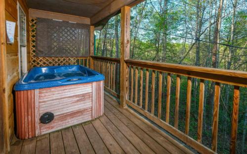 a jacuzzi tub sitting on a wooden deck at Honey Bear Heaven in Gatlinburg