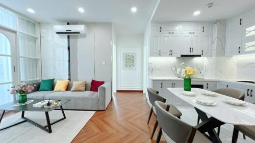 a kitchen and living room with a couch and a table at Vinhomes Time City Luxury Apartment in Ha Noi in Hanoi