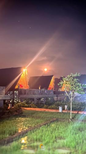 a train is parked in front of a building at night at Habarana Tree House Ambasewana Resort in Habarana