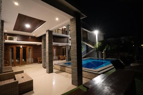 a house with a swimming pool at night at Barton Beach Inn in Nusa Penida