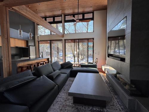 a living room with a couch and a fireplace at Forest Gardens by Hakuba White Fox Company in Hakuba