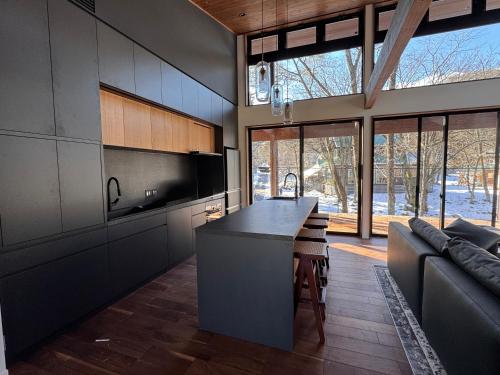 a kitchen with a island in the middle of a room at Forest Gardens by Hakuba White Fox Company in Hakuba