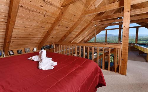 a bedroom with a red bed in a attic at Peak A View in Sevierville