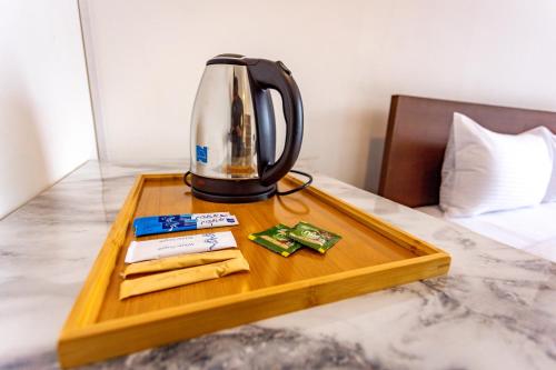 a coffee maker on a tray on a bed at Liselma Residence in Kandy