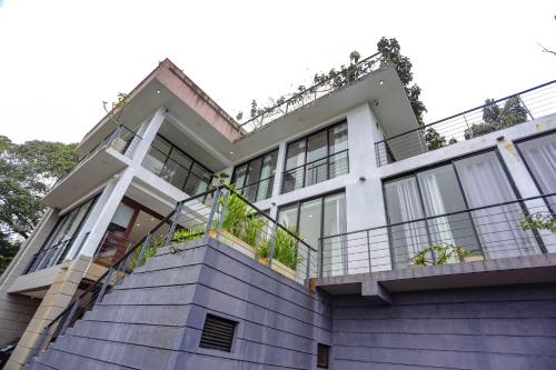 a house with a balcony with plants on it at Liselma Residence in Kandy