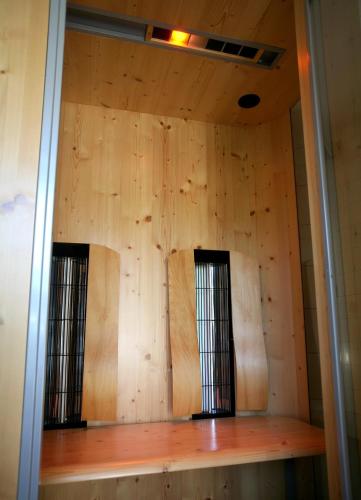 a room with two windows in a wooden wall at Ostseehotel Wustrow in Wustrow