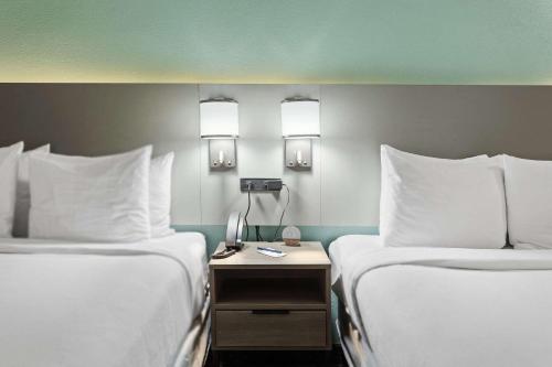 a hotel room with two beds and a table with a phone at Comfort Inn Chandler - Phoenix South I-10 in Chandler