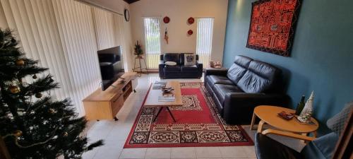 a living room with a christmas tree and a couch at Ocean Street Delight in Esperance