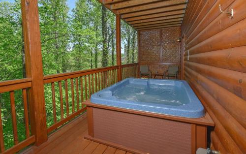 a hot tub on the deck of a cabin at Bear Footin Heaven in Pigeon Forge