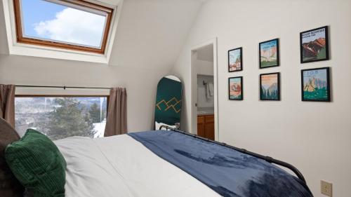 a bedroom with a bed and a surfboard on the wall at Clyde's Cabin home in Warren