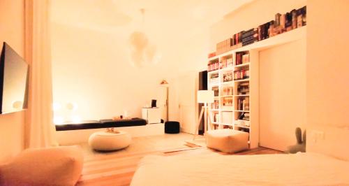 a living room with a couch and a book shelf at Matilde Rooms in La Spezia