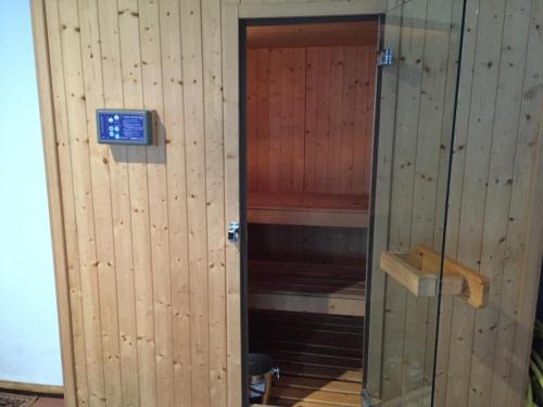 a wooden elevator with a door in a room at Hotel Campo Felice in Lucoli Alto