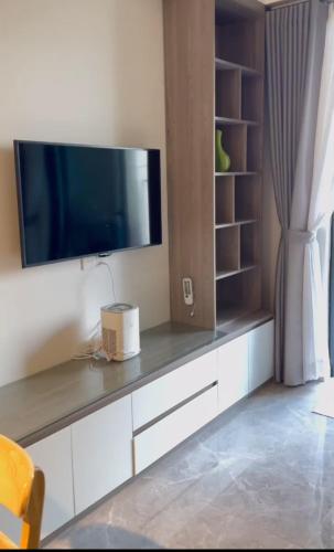 a living room with a tv on a wall at Swanbay - Căn Hộ 2PN in Cù Lao Ong Con