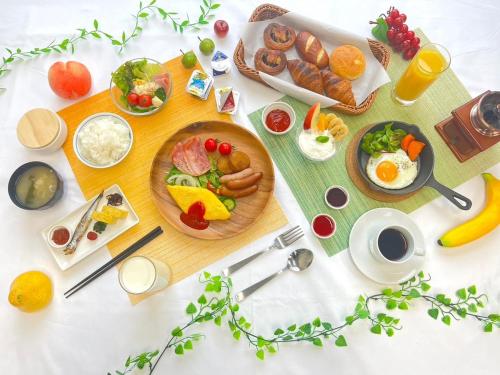 a table with breakfast foods and drinks on it at Hotel Route Inn Grand Asahikawa Ekimae in Asahikawa