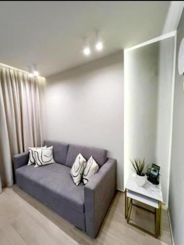 a living room with a couch and a table at 8 Blocks Apartments in Alexandroupoli