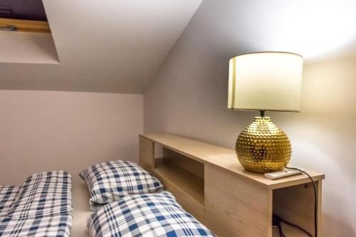 a bedroom with two beds and a lamp on a table at RSA Gold in Rowy
