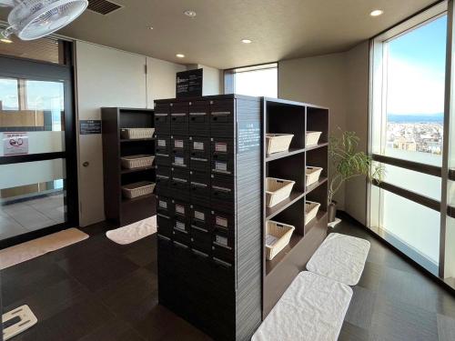 a room with a wine cellar with a shelf of wine bottles at Hotel Route Inn Grand Asahikawa Ekimae in Asahikawa