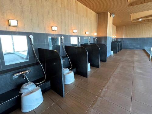 a row of toilets in a public restroom at Hotel Route Inn Grand Asahikawa Ekimae in Asahikawa