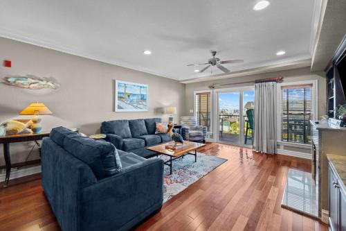 a living room with a couch and a table at Croatan Surf Club by KEES Vacations in Kill Devil Hills