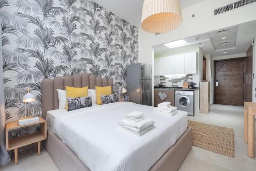 a bedroom with a large bed with towels on it at Lovely Studio & Budget Friendly in Dubai