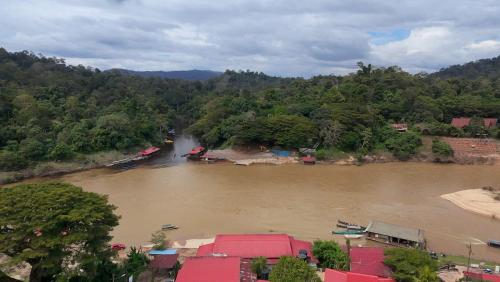 an aerial view of a river with houses and trees at Benteng Taman Negara in Jerantut