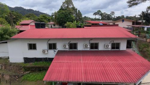 a white house with a red roof at Benteng Taman Negara in Jerantut