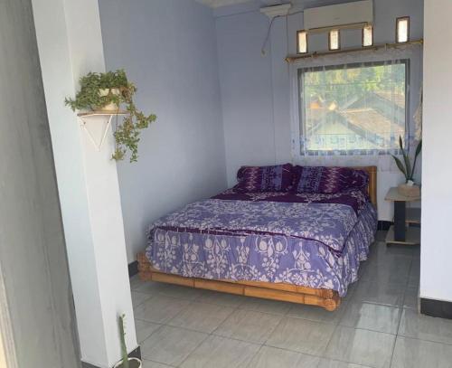 Ένα ή περισσότερα κρεβάτια σε δωμάτιο στο Hans Surfer Homestay
