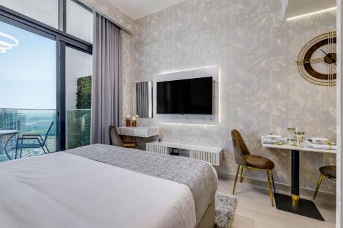 a hotel room with a bed and a television at GLOBALSTAY Azizi Riviera 48 in Dubai