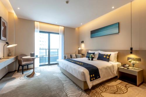 A bed or beds in a room at The Mulian Hotel, Chengdu Frontier Medical Center