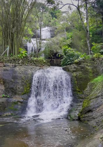 a waterfall in the middle of a river at Urava Farmstay- Private waterfall, near Vagamon, Thekaddy, Munnar in Kattappana