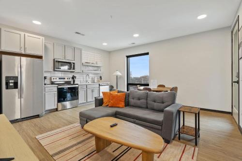 a living room with a couch and a table at CozySuites Mass w parking lounge & roof deck #26 in Indianapolis