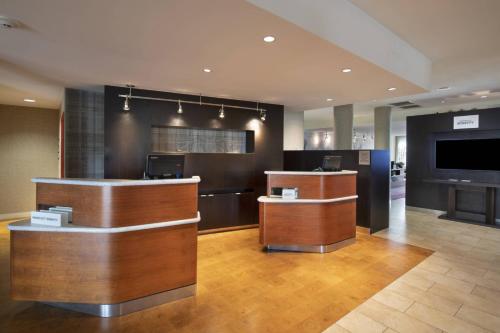 a hotel lobby with a bar and a tv at Courtyard Atlanta McDonough in McDonough