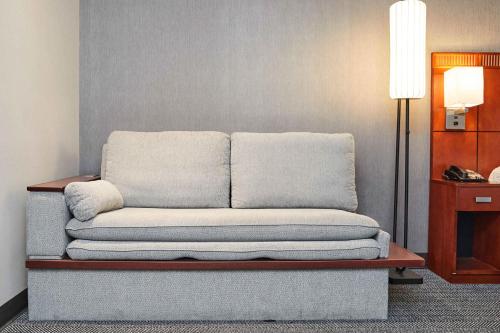 a couch sitting in the corner of a room at Courtyard Medford Airport in Medford