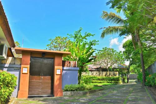 a small house with a door on a street at Private Pool Villas Kuta Bali in Kuta
